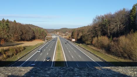 view from a bridge down to the german autobahn with many cars passing