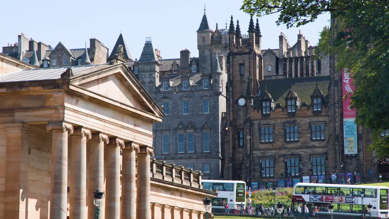 Daytime city scene with buses moving past neoclassical and medieval architecture, steady camera, natural light