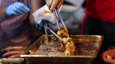 street food. pork meat being prepared and served