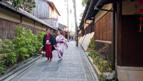 couple in kimonos walking down an old street