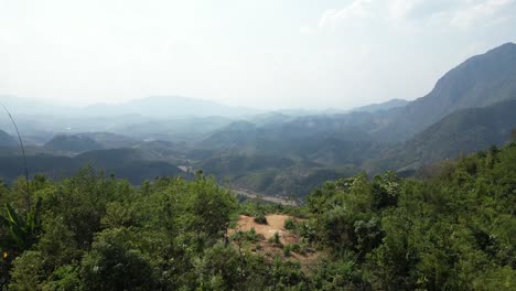 drone-shot-of-forest-in-the-mountains-on-a-hike-in-the-mountain-town-of-Nong-Khiaw-in-Laos,-Southeast-Asia