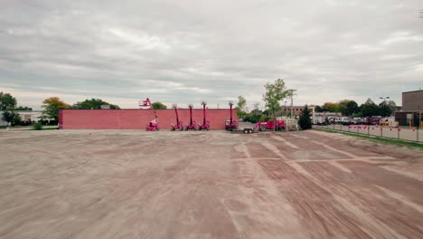 telescopic boom lifts on a construction dirty parking lot