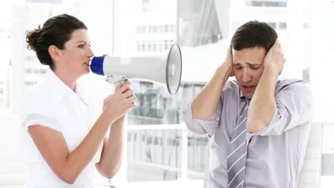 brunette businesswoman yelling through a megaphone