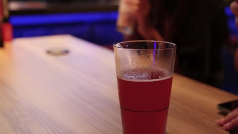 friends toasting drinks at a bar table