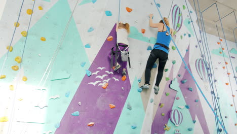 mother and daughter rock climbing