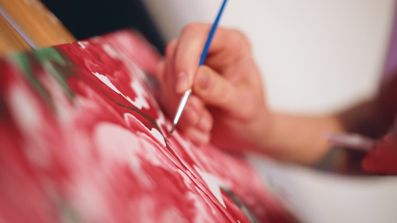 Red Floral Art, Deliberate Brush Movements Form Detailed Petal Patterns On Canvas, Handcrafted Red Flower Painting Features Fine Brushwork And Textured Acrylic Finish In Warm Studio Lighting