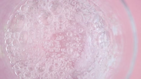 pouring sparkling water into a glass
