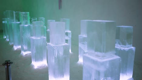 clear ice block sculptures on display in museum, pan left