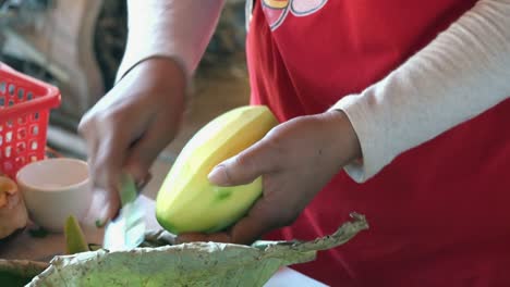 slow motion shot of fruit being peeled at a khmer cooking class in cambodia