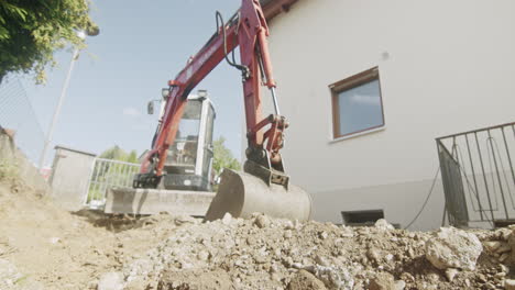 Wideangle-wide-shot-of-a-mini-excavator-parked-on-a-private-driveway