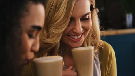 Smiling-friends-having-a-glass-of-cold-coffee