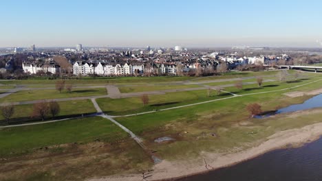 Drone-Footage-of-Duesseldorf-Oberkassel-over-the-river-rhine,-in-sunny-winter-weather,-first-row-property