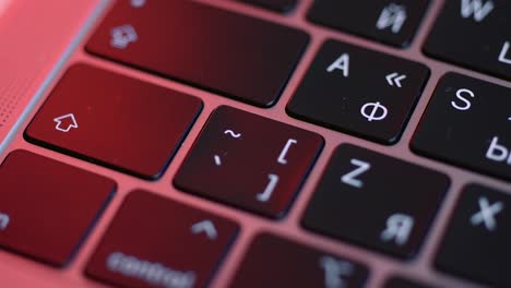 close-up of a laptop keyboard with red lighting