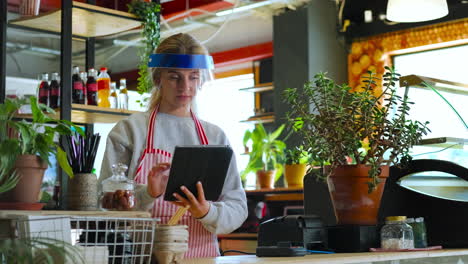 cafe employee taking order on tablet