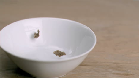 cereals falling in super slow motion in a bowl