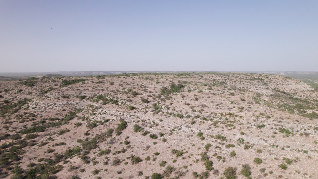 Aerial view of a west Texas desert hill top reveals a vast expanse of desolate landscape