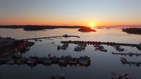strömstad stromstad sweden aerial drone boat trolling arctic golden sunset sun on horizon sandelfjord fjord baltic sea seaside town marina harbor picturesque koster islands oscarspromenaden forward