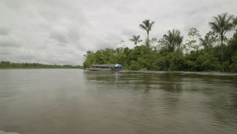 amazonian river passenger boat travelling at speed on an overcast day