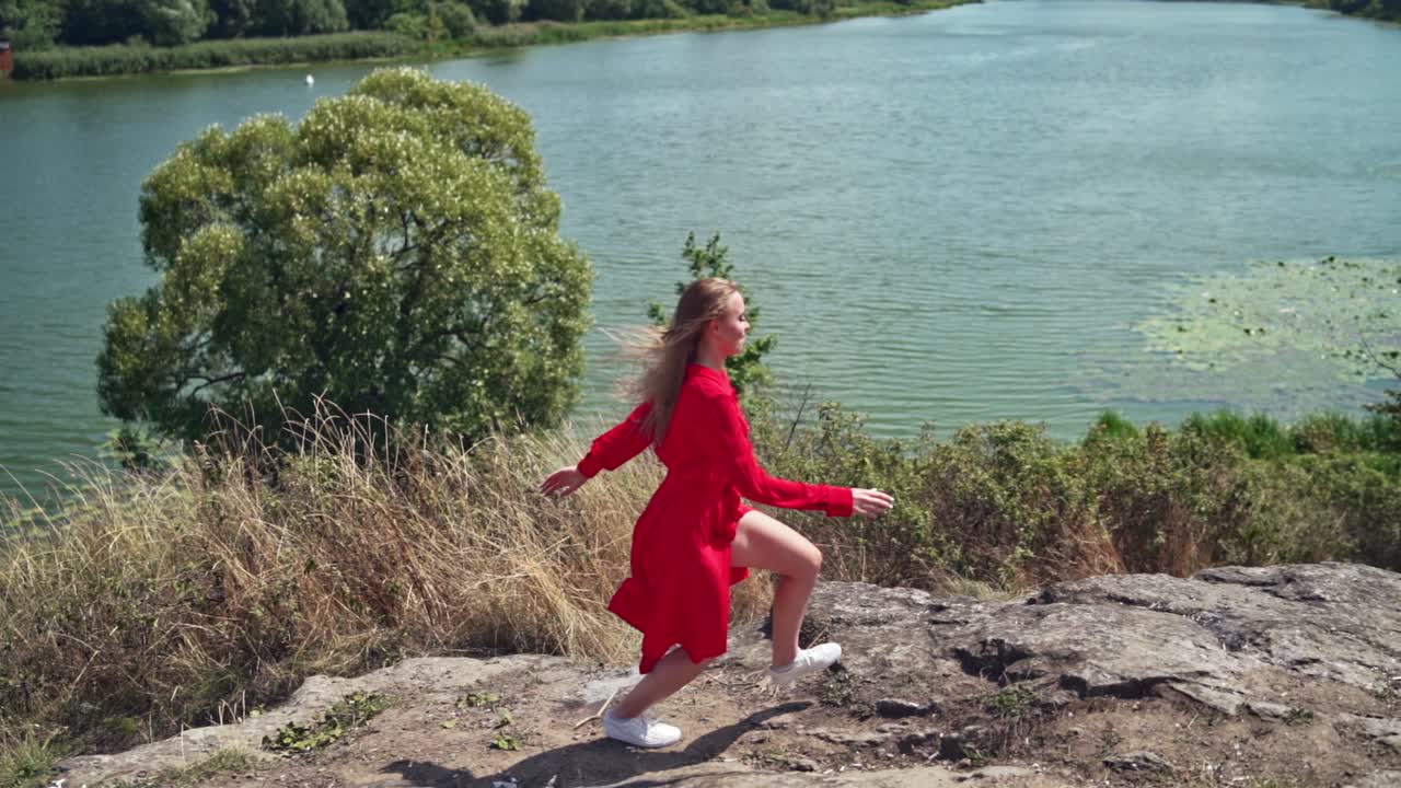 Carefree young woman on nature. View of free woman enjoying life on nature