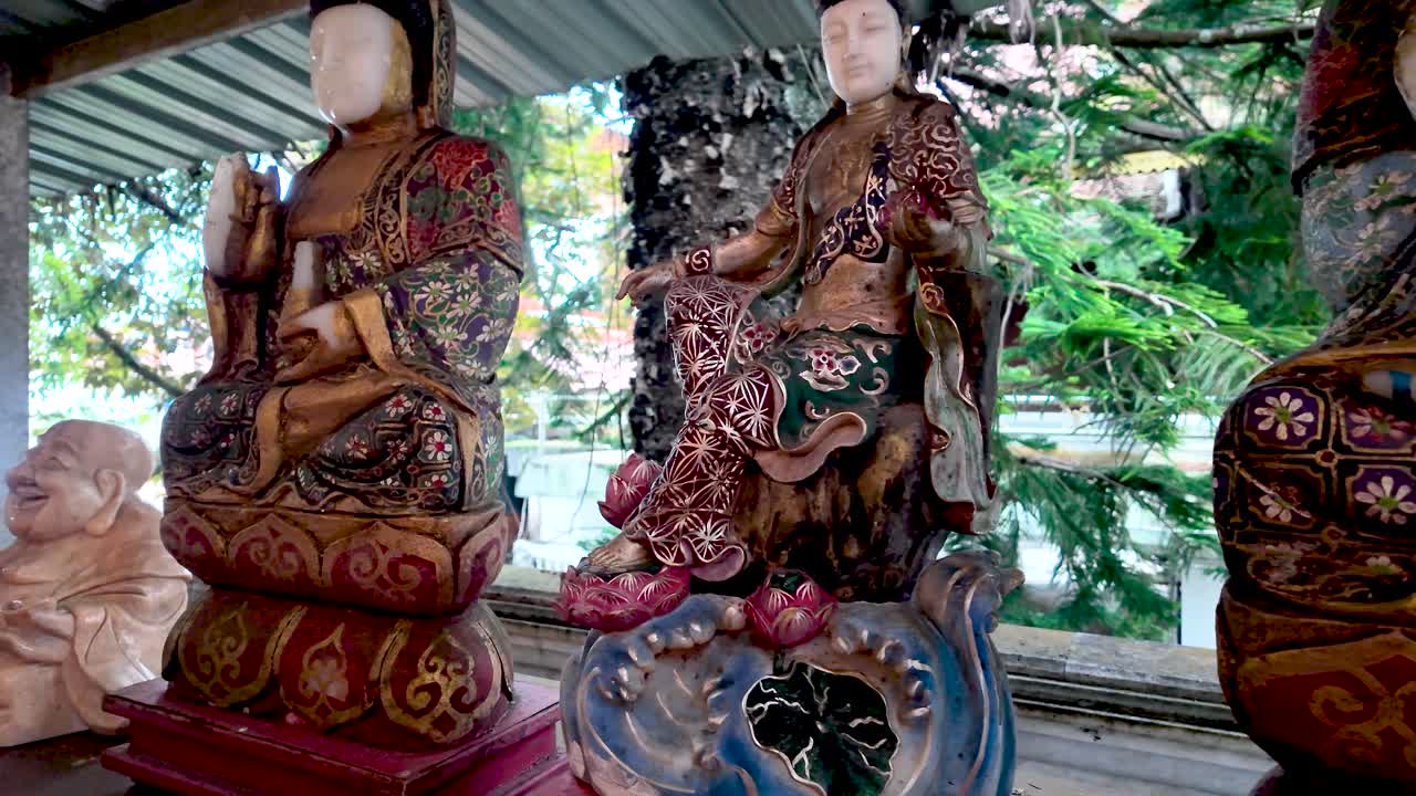 Colorful Buddha statues in a Thai temple with intricate patterns and serene, meditative presence