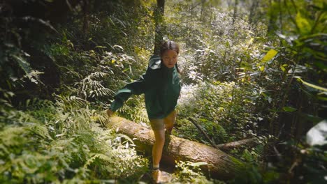 young asian girl hiking the jungle in slow motion at sunset