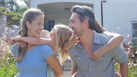 Lovely-parents-giving-piggy-back-to-their-daughters