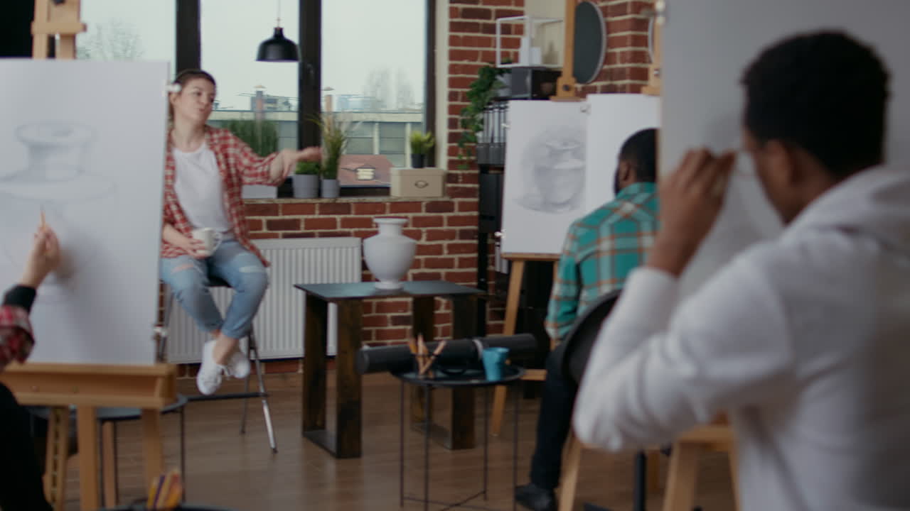 Young woman explaining drawing technique to students