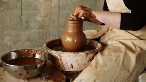 Female-Potter-Cuts-Off-Excess-Clay-On-The-Top-Of-The-Vase