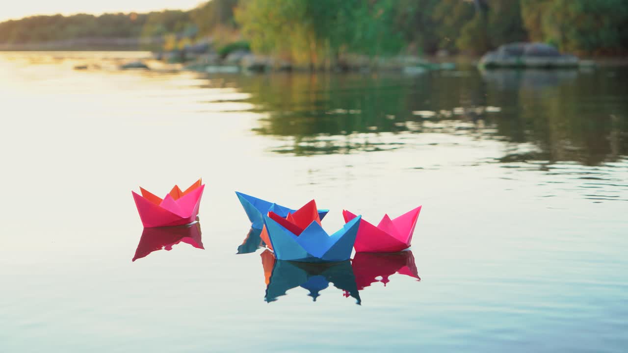 Paper boats on the water. Colored paper ships in the water