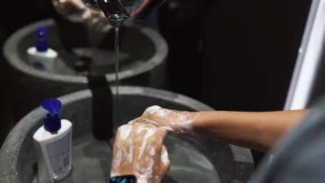 washing hands in a public restroom