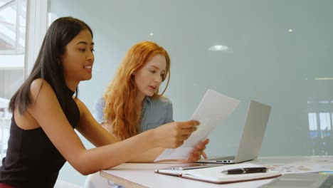 executives discussing over laptop and document 4k