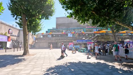 people gathering at southbank centre on a sunny day