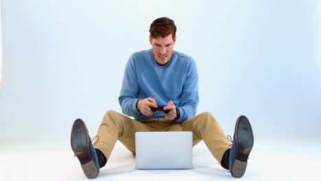 Man playing joystick game on laptop 4k