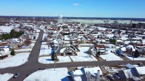 flying over a suburban neighborhood after a day of snow