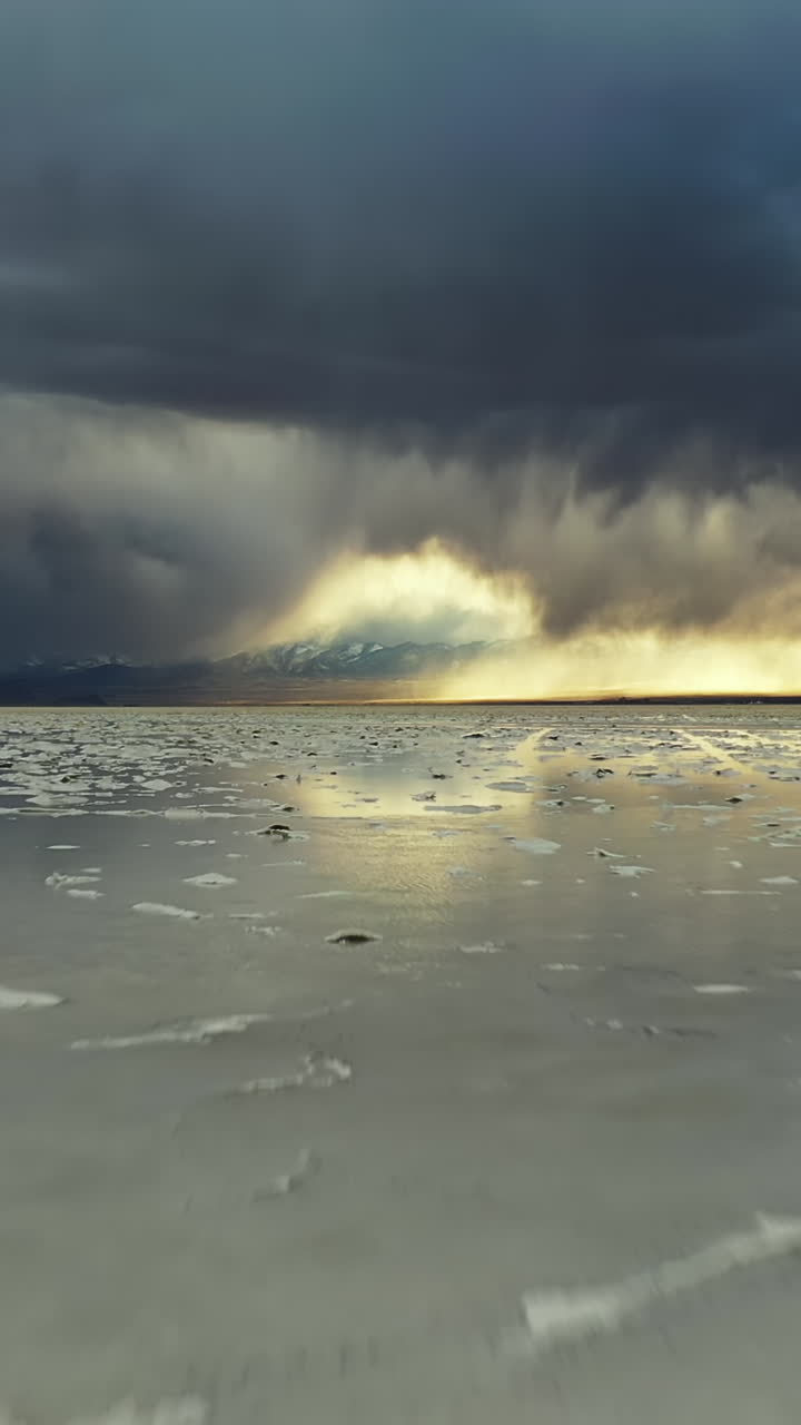 Bonneville Salt Flats, Utah. Vertical Drone Shot of Water Water Dramatic Sky Reflection and Soil
