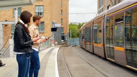 pendler warten auf den zug am bahnhof 4k