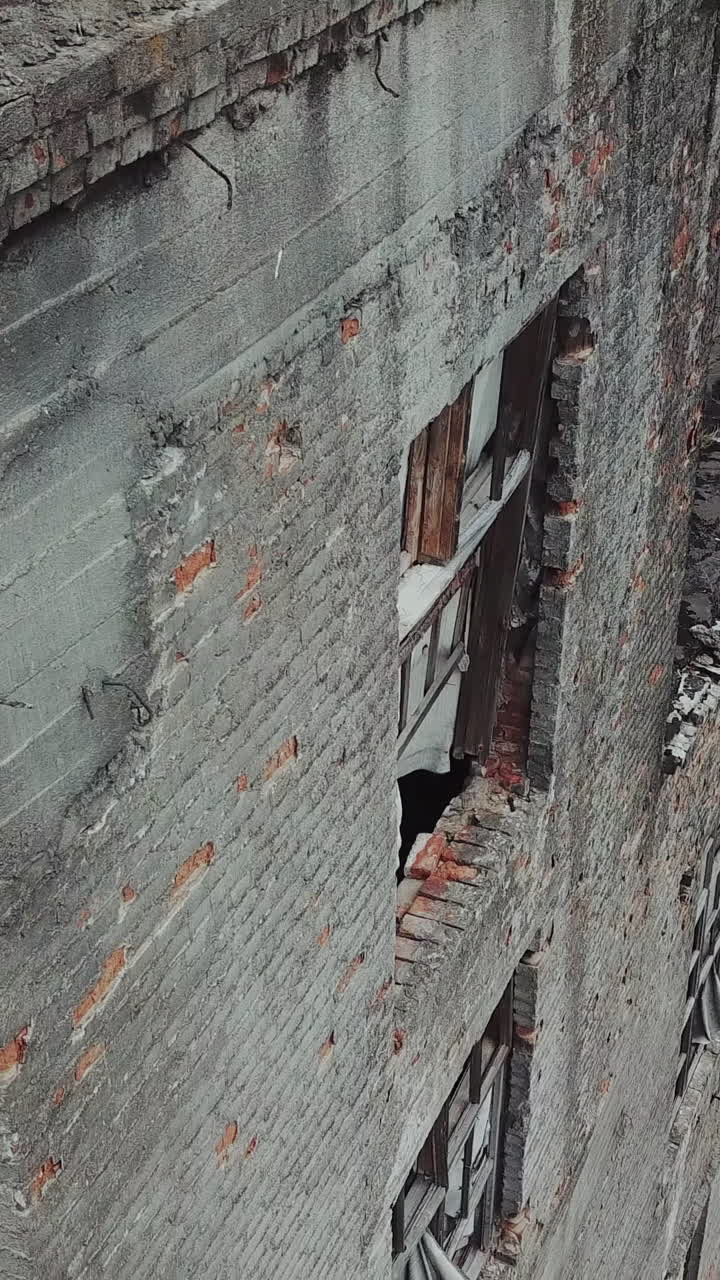 Ruins of an old factory. Old industrial building for demolition. Aerial view Vertical video