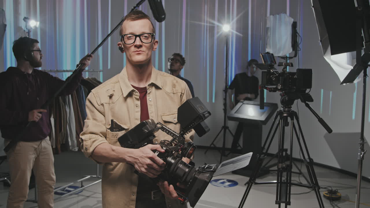 Portrait Of Video Operator With Camera In Filmmaking Studio