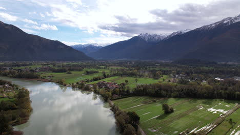 aerial view of como lake italy, with river flowing through a lush green valley