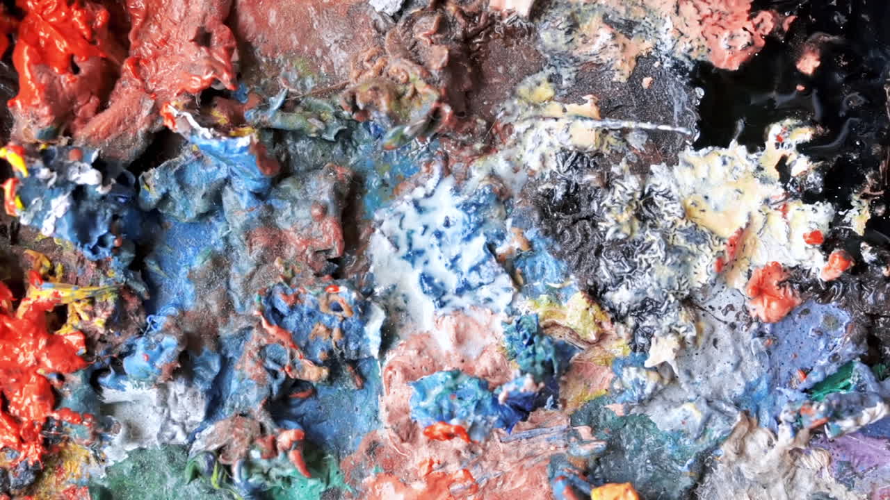 Used palette in a studio with a lot of dry paint on it