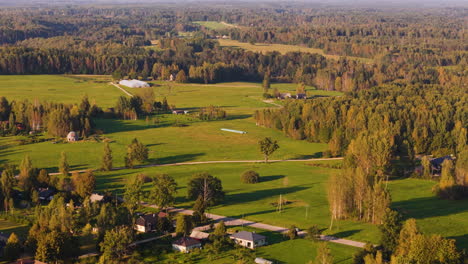 car traveling through the baltic farmlands and rural countryside of augsligatne, latvia.