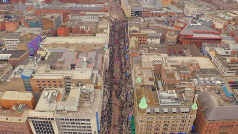 descending aerial dolly of st. patrick’s day parade in central belfast