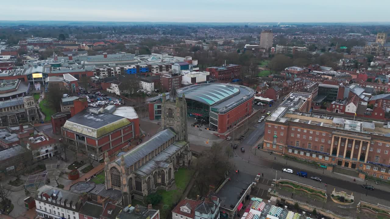 Norwich city center with historic churches, shops, and modern buildings, aerial view