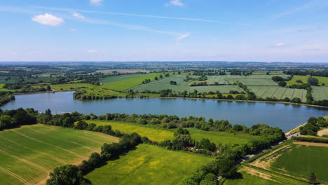 stunning ariel landscape of countryside with rural fields and boddington reservoir in northamptonshire, england