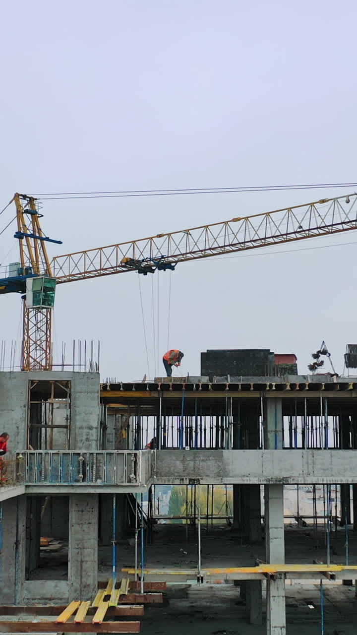 Flying over the construction site. Construction crane on building background