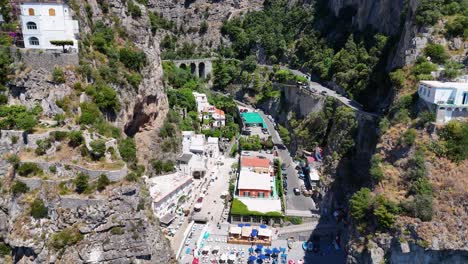 Slow-Aerial-reveal-Over-Marina-di-Praia-Beach,-Amalfi-Coast,-Campania-Region,-Italy,-Tyrrhenian-Sea