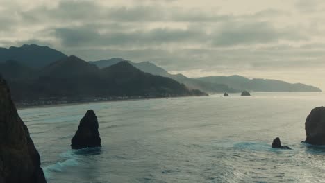 4k aerial big rock in the ocean on west coast drone dolly out