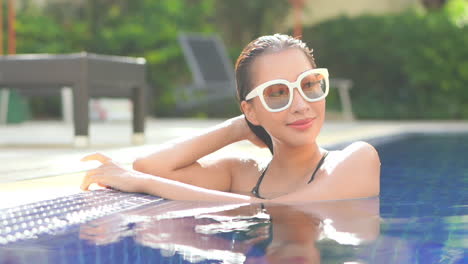 pretty woman standing in exterior swimming pool