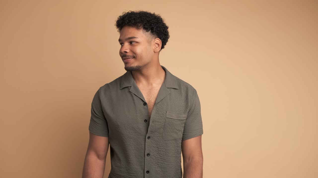 Positive man standing with satisfied expression on face