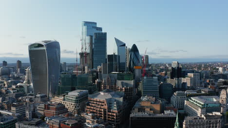 Elevated-view-of-group-of-modern-office-buildings-in-afternoon-bright-sunlight.-Futuristic-skyscrapers-towering-above-city.-London,-UK